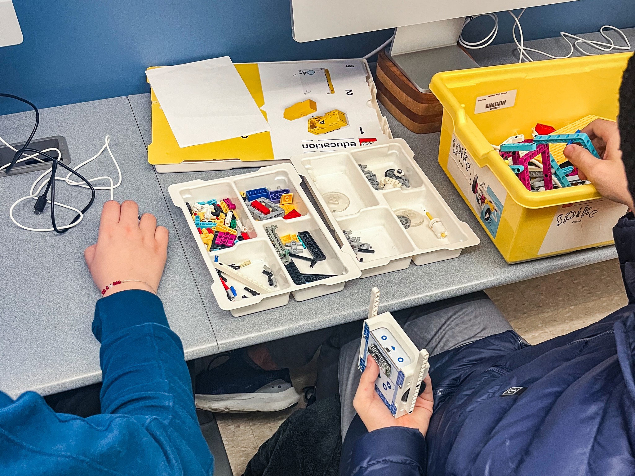 Close-up of a high school student using the Arduino Alvik robot car with lego during usability testing session