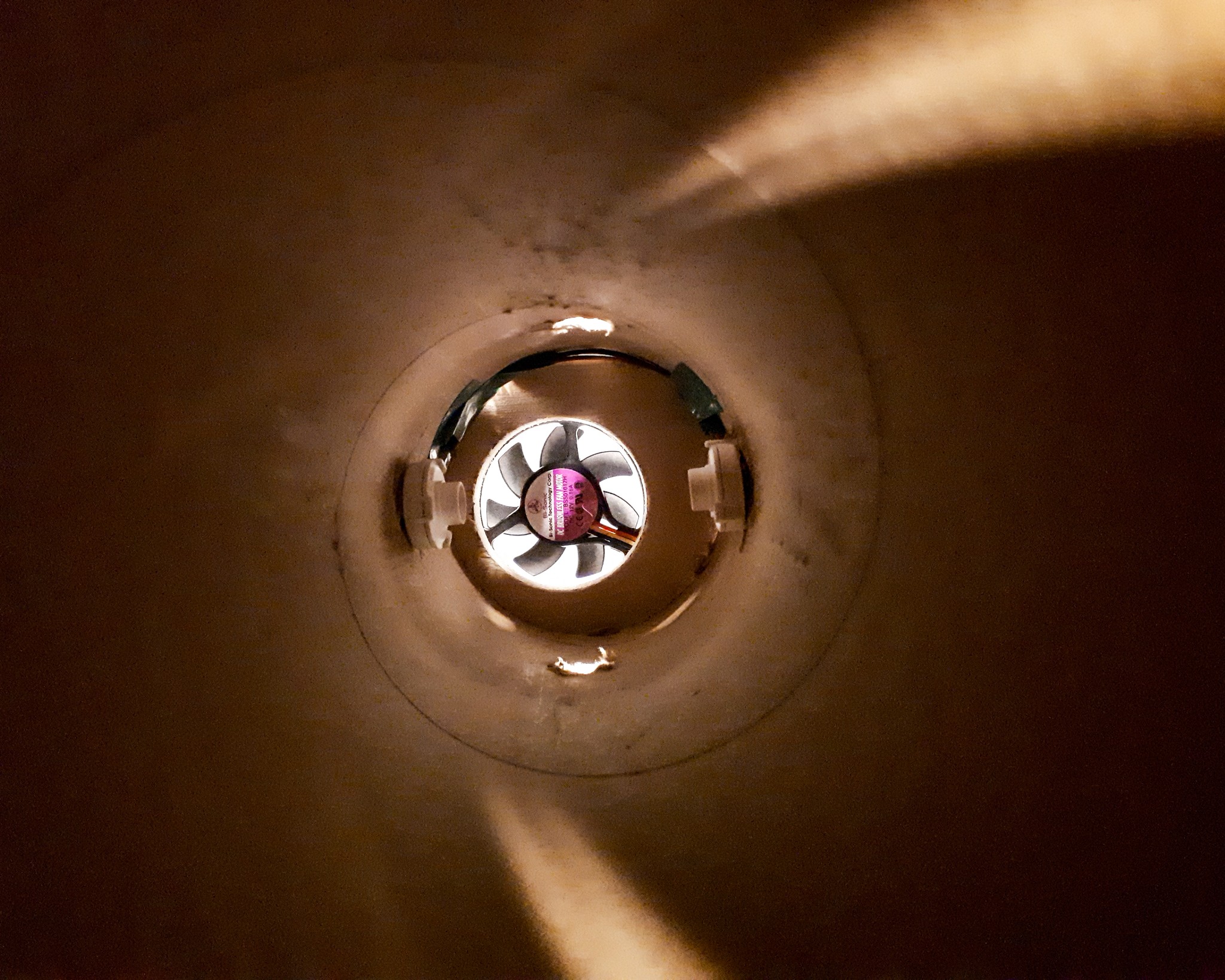 a hard cardboard funneling system for scentony with a fan and two scent dispensers mounted at the bottom