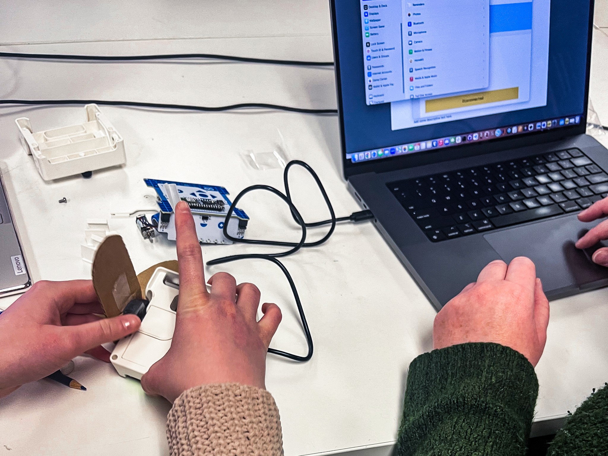 Close-up of a TUFTS University student using the Arduino Alvik robot car during usability testing session