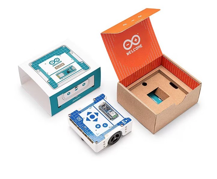 the Arduino Alvik Robot Car on a table with its squared orange and blue original packaging